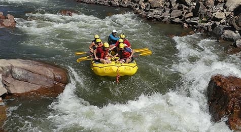 Whitewater rafting group navigating Class IV rapids through the Royal Gorge on the Arkansas River, Canon City Colorado